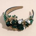 Detailed macro view of baroque headband featuring velvet roses and emerald rhinestones - Green