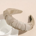 Detail view of champagne gold pleated velvet headband with sparkling silver rhinestones - Champagne