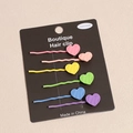 Close-up of six colorful matte heart-shaped hair clips in pastel candy colors on display card - Large Heart