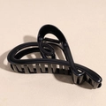 Dettaglio di un mollettone per capelli nero lucido a forma di cuore dal design cavo - Nero Lucido