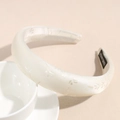 Detail showing the thick padded texture and jacquard floral pattern on ivory headband - White