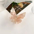 Detail of pink butterfly hair claw clip with shimmer finish and double-layered wing design - Milk Tea