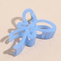 Detailed macro view of a large translucent blue butterfly hair claw clip with gold spring - Sky Blue