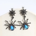 Detailed close-up of spider web drop earrings with a blue gemstone drop for women - Blue Sapphire Spider Style / Spider