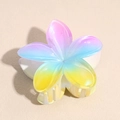 Macro shot of colorful gradient plumeria hair claw clip with glossy resin finish - Pink Blue Yellow Gradient