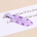 Detail of pink-purple resin hair clip with grape pattern on a textured background - Grape Purple