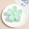 Detail showing mint green floral hair claw clip with marble texture for hairstyles - Green