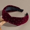 Detail eines burgunderroten Samtstirnbands mit Knotendesign und funkelnden Strasssteinen - Burgunderrot