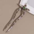Dettaglio della forcina a stella marina in acetato con strass verde e trama marmorizzata - Grigio