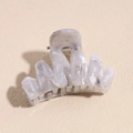 Detail of grey marble plastic hair claw clip with golden metal spring and glossy finish - 4.5cm Gray Wavy Claw
