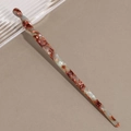 Close-up of vintage acetate hair stick with marble texture and spiral twist design - Blue Brown