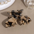 Détail d'une pince à cheveux papillon avec motif écaille de tortue et strass brillants - Papillon Léopard