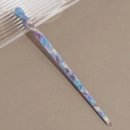 Macro shot of marble textured acetate hair stick with blue and purple swirling patterns - Smudged Purple Blue