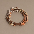 Detail of multi-color knitted elastic hair tie with textured pom-poms and brown joiner - Dark Brown