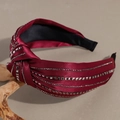 Detail of burgundy satin headband with rhinestone embellishments and knotted side design - Burgundy