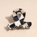 Detailed close-up of checkerboard acetate hair claw with gold Barrette La France text - 4.2cm Checkered Black White