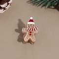 Close-up of gingerbread man hair clip with gold sequins and festive Christmas scene background - Glitter Gingerbread Man