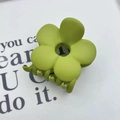 Matte lime green flower hair claw clip for women displayed on aesthetic paper background - Green