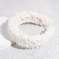 Detailed view of plush white faux lamb wool headband texture on a minimalist stone surface - White