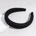 Close-up of black chunky knit headband featuring thick ribbed texture and a soft sponge base - Black
