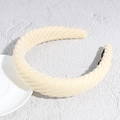 Detail shot of beige knitted headband showing thick textured weave and black non-slip lining - White