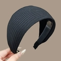 Detail of black wide knit headband showing ribbed fabric texture and elastic band - Black