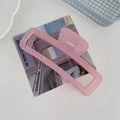 Large rectangular light pink matte claw clip for hair styling shown in modern setting - Rectangular Claw Clip / Jelly Pink