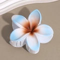 Detailed macro view of light blue gradient frangipani flower hair claw with secure white teeth - Lily Blue Brown Stamen