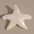 Detailed close-up of starfish claw clip with golden sand textures and pearly white resin - Beige