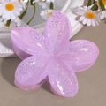 Detailed macro view of a lavender glitter flower hair claw clip with a resin finish - Lily Flower Purple
