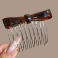 Close-up of elegant tortoise shell acetate bow hair comb with polished metal teeth - Blue Brown Bow (Tortoiseshell)