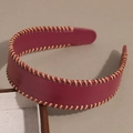 Detail van een bordeauxrode PU-lederen haarband met decoratieve bruine handgeweven stiksels - Bordeauxrood