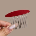Detailed close-up of a 10-tooth silver metal hair comb with a red acetate oval top piece - Small Linear Red
