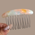 Close-up of marble acetate hair comb with golden France handmade text and 12 metal teeth - Linear Pink Yellow Green (Iridescent)