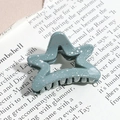 Detailed close-up of a star-shaped sage green hair claw clip with silver glitter accents - Pentagram / Gray Green (Splash Ink)