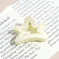 Detail of star-shaped hair claw clip in cream yellow with silver splatter texture - Pentagram / Cream Yellow (Splash Ink)