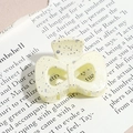 Macro shot of cream bow hair claw clip with silver ink splatter and metal spring - Bow / Cream (Splash Ink)