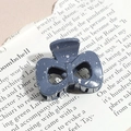 Detail of a dark grey triangle hair claw clip with white splatter pattern on a magazine - Bow / Dark Gray (Splash Ink)