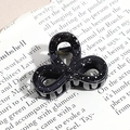 Close-up of black triangle hair claw clip with silver ink splatter pattern on retro paper - Three-Petal Flower / Black (Splash Ink)