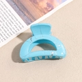 Nahaufnahme einer himmelblauen Haarklammer mit Marmortextur auf stilvollem Hintergrund - Halbkreis / Blau