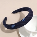 Detail of navy twill headband with bow embroidery and handmade tag by coffee cup - Navy Blue