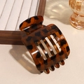 Detail of tortoiseshell matte square hair claw clip with sharp texture on warm background - Yellow Brown Leopard