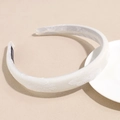 Detailed close-up of cream satin headband with white floral embroidery and sponge padding - White