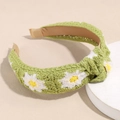 Close-up of green knitted headband featuring white daisy floral patterns and knot detail - Green Flower