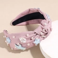 Primer plano de la diadema rosa con nudo, perlas blancas, estrellas de mar y conchas de mar - Rosa