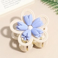 Close-up of matte five-petal flower hair claw clip in cream and light blue finish - Light Purple