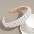 Close-up of sparkling crystals and silver rhinestones on a white beaded wide headband - White