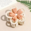 Detail of matte flower hair claw clip with orange petals and cream bead circular trim - Orange