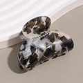 Macro shot of French acetate hair claw with geometric patterns and sparkling rhinestones - Gray