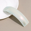 Detail of mint blue acetate hair clip with pearlescent finish and France Handmade stamp - Green